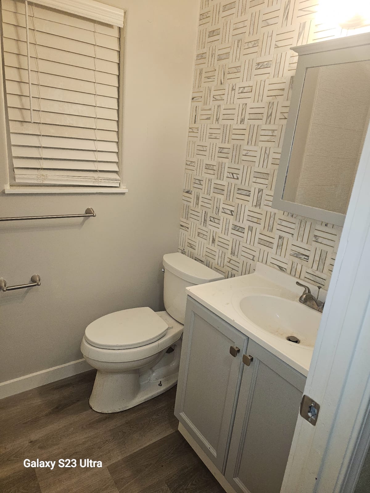 Updated bathroom with modern vanity and stylish wall accents