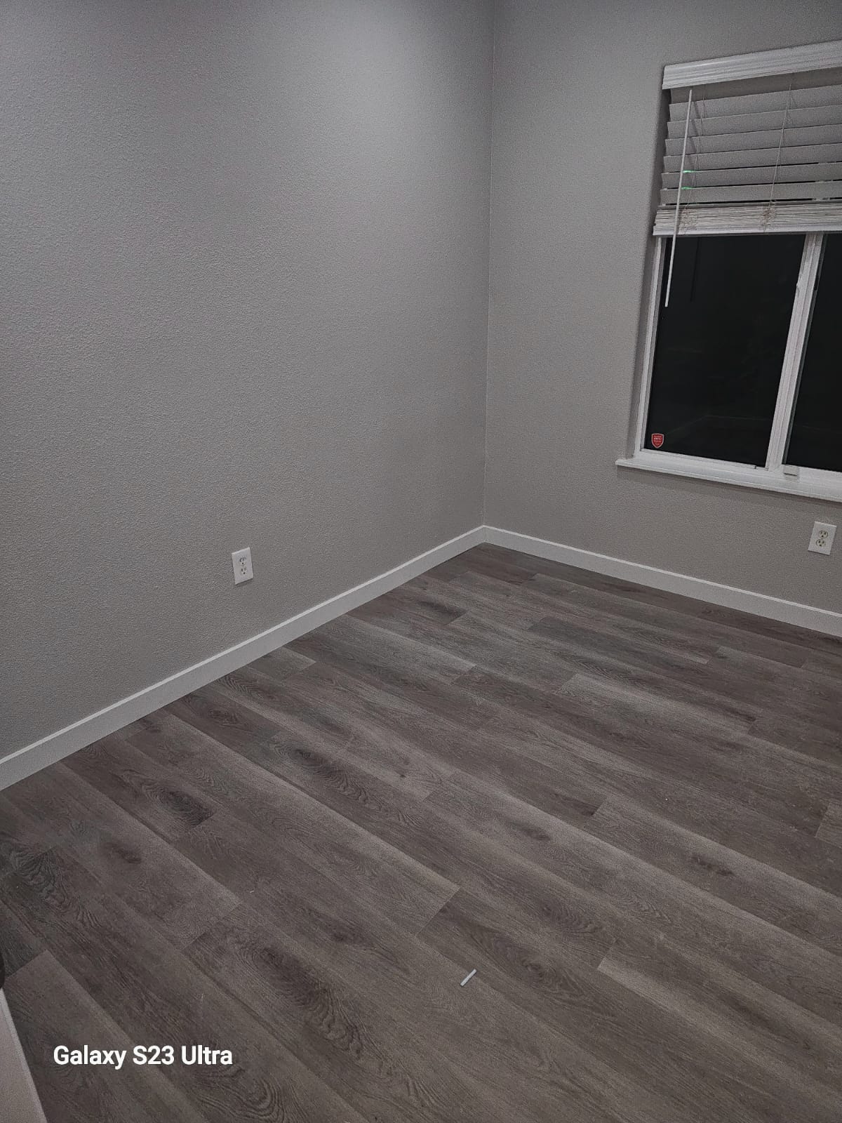 Elegant bathroom remodel featuring sleek flooring and new toilet
