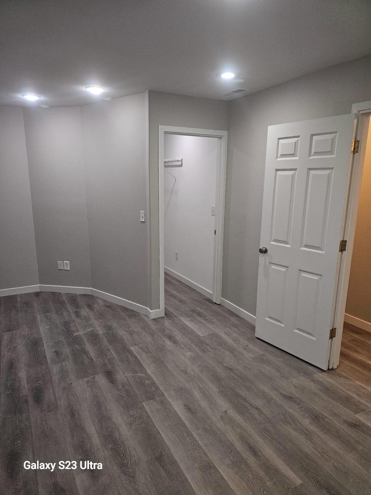 Walk-in closet showcasing freshly remodeled flooring