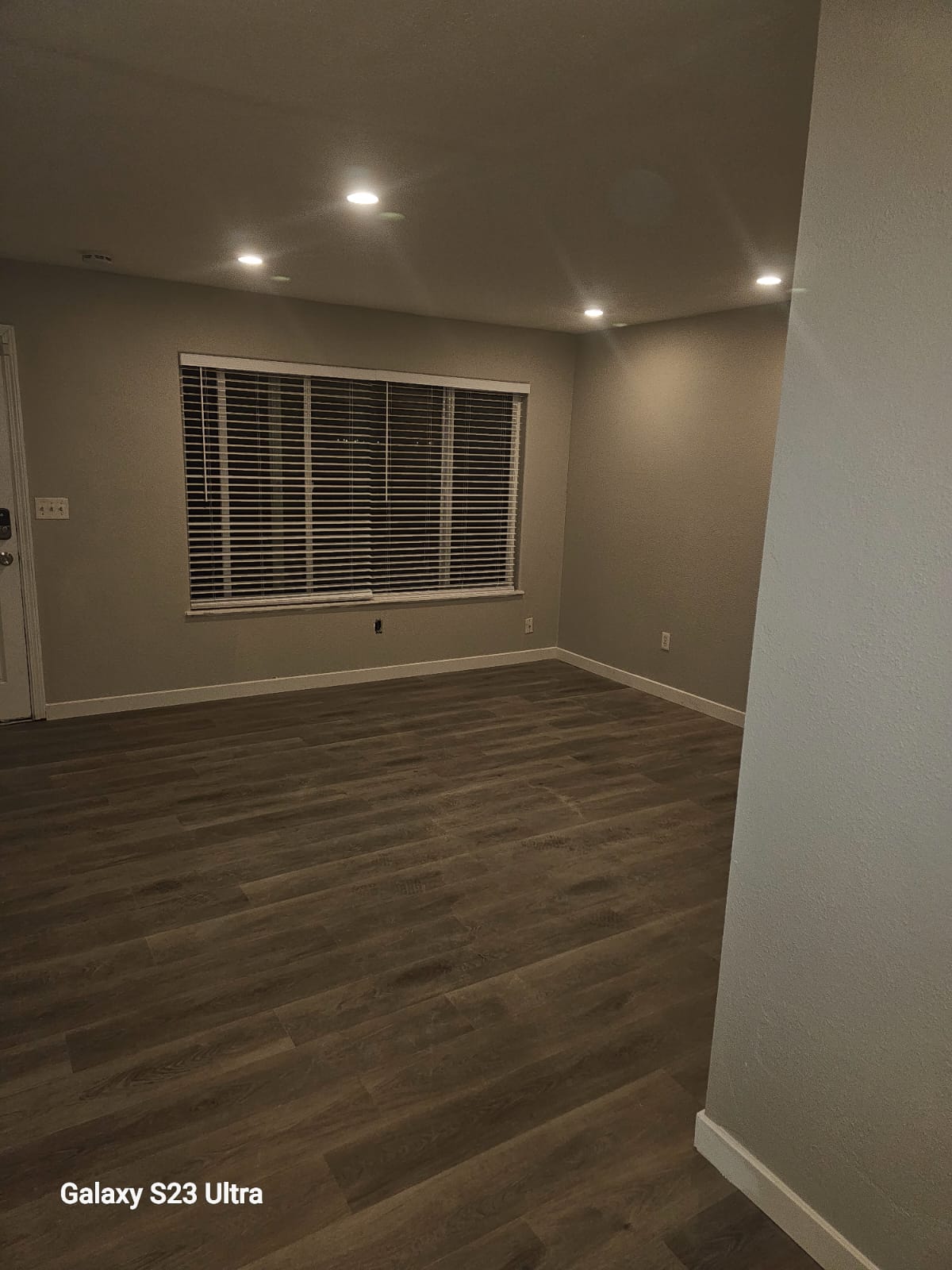 Modernized room with updated flooring and walls
