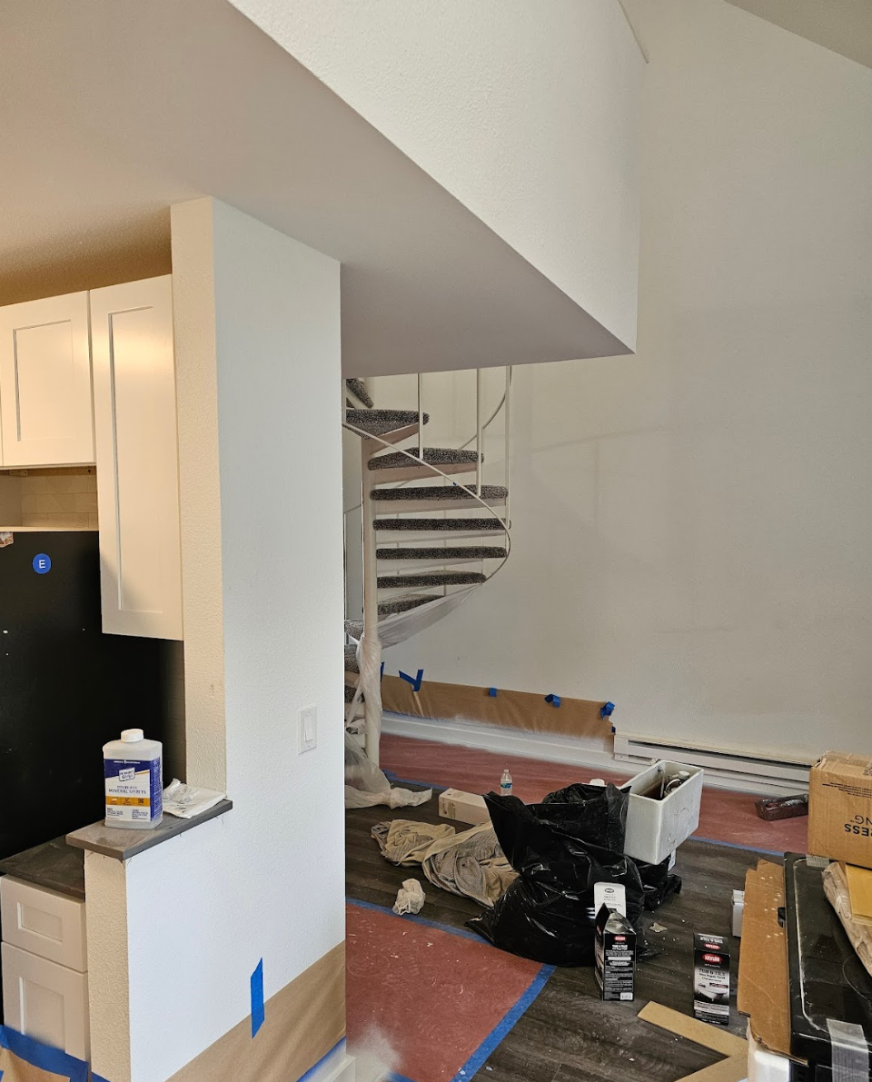 View of the kitchen and staircase prepared for professional painting