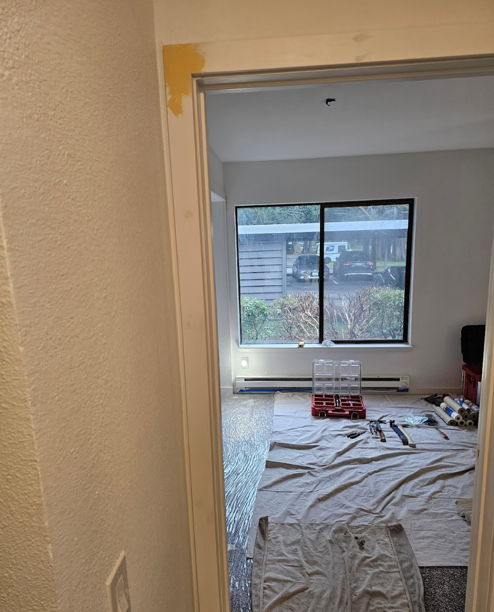 Room prepared for painting with protective covers and clean edges